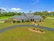 A beautiful home with lush landscaping, a circular driveway, and a manicured lawn at 5600 Blackjack S Ct, Punta Gorda, FL 33982