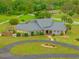 Charming home with stone accents, a circular driveway, and a lush green lawn, showcasing its inviting curb appeal at 5600 Blackjack S Ct, Punta Gorda, FL 33982