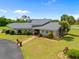 Lovely home with stone and siding, lush landscaping, and a circular driveway, perfect for curb appeal at 5600 Blackjack S Ct, Punta Gorda, FL 33982