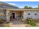 Inviting front porch with stone pillars and a cozy seating area, enhanced by lovely plants and decorative accents at 5600 Blackjack S Ct, Punta Gorda, FL 33982