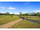 Beautifully landscaped front yard featuring a brick paver walkway leading to the paved driveway at 5600 Blackjack S Ct, Punta Gorda, FL 33982