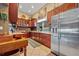 Well-appointed kitchen with wooden cabinets, granite countertops, and stainless steel appliances, offering style and functionality at 5600 Blackjack S Ct, Punta Gorda, FL 33982