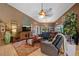 Cozy living room featuring a comfortable leather sectional, stylish rug, and tasteful decor, creating a welcoming atmosphere at 5600 Blackjack S Ct, Punta Gorda, FL 33982