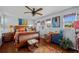 Bright main bedroom with hardwood floors, colorful decor, and natural lighting at 5600 Blackjack S Ct, Punta Gorda, FL 33982