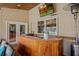 Covered outdoor bar area with sink, seating, and scenic backyard views at 5600 Blackjack S Ct, Punta Gorda, FL 33982