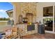 Outdoor kitchen and cooking area featuring stone accents and a functional layout at 5600 Blackjack S Ct, Punta Gorda, FL 33982