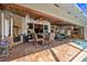 The covered outdoor patio features tile floors, a wood ceiling, a dining table, seating, and a fireplace at 5600 Blackjack S Ct, Punta Gorda, FL 33982