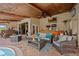 Spacious outdoor patio with cozy seating area, fireplace, and bar area by the pool at 5600 Blackjack S Ct, Punta Gorda, FL 33982
