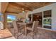Covered outdoor dining area featuring a stone fireplace and brick-paved patio at 5600 Blackjack S Ct, Punta Gorda, FL 33982