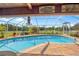 Stunning pool view with a screened lanai, an outdoor kitchen, and a cozy lounge area at 5600 Blackjack S Ct, Punta Gorda, FL 33982