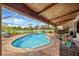 Inviting outdoor pool area with comfortable seating, outdoor dining, and a serene backyard view at 5600 Blackjack S Ct, Punta Gorda, FL 33982