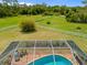 An enclosed pool area with brick pavers, plants, furniture and view to the fenced acreage surrounding the property at 5600 Blackjack S Ct, Punta Gorda, FL 33982