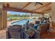 Inviting screened-in pool area with comfortable wicker furniture, ceiling fans, and a scenic backyard view at 5600 Blackjack S Ct, Punta Gorda, FL 33982
