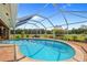 Spacious screen enclosed pool with brick pavers and view of the lush backyard and acreage at 5600 Blackjack S Ct, Punta Gorda, FL 33982