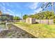 Spacious backyard featuring a storage shed, well-maintained lawn, and a serene outdoor setting at 566 Reading Nw St, Port Charlotte, FL 33952