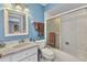 Well-lit bathroom features a shower-tub combination and white vanity at 566 Reading Nw St, Port Charlotte, FL 33952