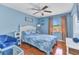 Bright bedroom features stylish decor, ceiling fan, and warm hardwood floors at 566 Reading Nw St, Port Charlotte, FL 33952