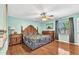 Spacious bedroom with wooden furniture, ceiling fan, and warm hardwood floors at 566 Reading Nw St, Port Charlotte, FL 33952