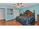 Comfortable bedroom with wooden furniture, ceiling fan, and hardwood floors at 566 Reading Nw St, Port Charlotte, FL 33952