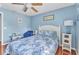 Cozy bedroom with comfortable bed, accent chair, and light blue walls at 566 Reading Nw St, Port Charlotte, FL 33952