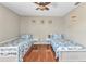 Bright bedroom features two twin beds and warm hardwood floors at 566 Reading Nw St, Port Charlotte, FL 33952