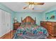 Comfortable bedroom with wooden furniture, ceiling fan, and hardwood floors at 566 Reading Nw St, Port Charlotte, FL 33952