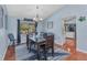 Dining room with beach house decor, wood floors, and an open layout to the kitchen area at 566 Reading Nw St, Port Charlotte, FL 33952
