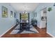 Charming dining room featuring wood floors, coastal decor, and an open layout to the kitchen at 566 Reading Nw St, Port Charlotte, FL 33952