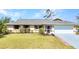 Charming single-story home featuring a well-maintained lawn and an attached two-car garage at 566 Reading Nw St, Port Charlotte, FL 33952