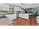 Bright kitchen features granite countertops, stainless steel appliances, and open access to the living area at 566 Reading Nw St, Port Charlotte, FL 33952