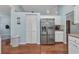 Modern kitchen featuring stainless steel appliances, ample cabinet space, and wood-look flooring at 566 Reading Nw St, Port Charlotte, FL 33952