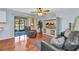 Cozy living room with wood floors, leather furniture, and sliding glass doors to the patio at 566 Reading Nw St, Port Charlotte, FL 33952