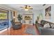 Bright living room with wood floors, comfortable seating, and an entertainment center at 566 Reading Nw St, Port Charlotte, FL 33952