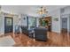 Inviting living room featuring wood-look flooring, a ceiling fan, and a decorative entertainment center at 566 Reading Nw St, Port Charlotte, FL 33952