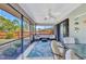 Relaxing screened patio featuring comfortable seating and a ceiling fan for a pleasant outdoor experience at 566 Reading Nw St, Port Charlotte, FL 33952