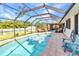 Sparkling pool in screened lanai with a lush backyard view, seating, and a tranquil outdoor space at 566 Reading Nw St, Port Charlotte, FL 33952