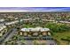 Wide aerial view of the condominium complex showcasing the neighborhood with canals and lush landscaping at 601 Shreve St # 64C, Punta Gorda, FL 33950