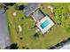 Aerial view of a pool area surrounded by lush green grass and lounge chairs at 601 Shreve St # 64C, Punta Gorda, FL 33950