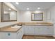 Bathroom featuring a double vanity with white cabinets and framed mirrors, offering plenty of space at 601 Shreve St # 64C, Punta Gorda, FL 33950