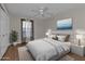 Serene bedroom with white bedding, matching nightstands, and ceiling fan at 601 Shreve St # 64C, Punta Gorda, FL 33950