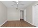 Bedroom with wood flooring, a ceiling fan, and ensuite access at 601 Shreve St # 64C, Punta Gorda, FL 33950
