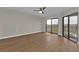 Bright bedroom with hardwood floors, a ceiling fan and sliding glass doors to the outside at 601 Shreve St # 64C, Punta Gorda, FL 33950