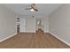 Bedroom features a ceiling fan, wood flooring, and access to a bathroom and kitchen at 601 Shreve St # 64C, Punta Gorda, FL 33950