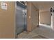 Hallway with elevator access and neutral decor in a well-maintained building, offering convenience at 601 Shreve St # 64C, Punta Gorda, FL 33950