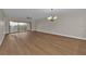 Open-concept living room with wood floors, ceiling fan and sliding glass doors at 601 Shreve St # 64C, Punta Gorda, FL 33950