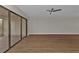 Living room with sliding glass doors leading to balcony and a ceiling fan at 601 Shreve St # 64C, Punta Gorda, FL 33950