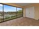 Screened-in patio offering relaxing views of the community pool and manicured landscaping at 601 Shreve St # 64C, Punta Gorda, FL 33950