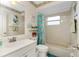 Classic bathroom featuring shower-tub combo, single sink vanity, and a decorative mirror at 6103 Fabian Rd, North Port, FL 34287