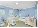 Bright bedroom featuring twin beds, ceiling fan, carpet, and natural light through window at 6103 Fabian Rd, North Port, FL 34287