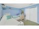 Bright bedroom featuring twin beds, ceiling fan, carpet, and a double closet for storage at 6103 Fabian Rd, North Port, FL 34287